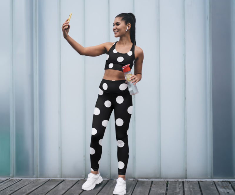 sublimated leggings and sports bra mockup of a happy woman taking a selfie m r el